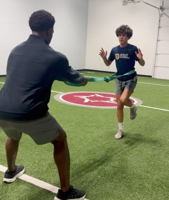 Patient working with a provider at a performance physical therapy clinic in Dallas, TX during a functional movement assessment