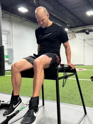 Patient working with a provider at a performance physical therapy clinic in Dallas, TX during a one-on-one evaluation session