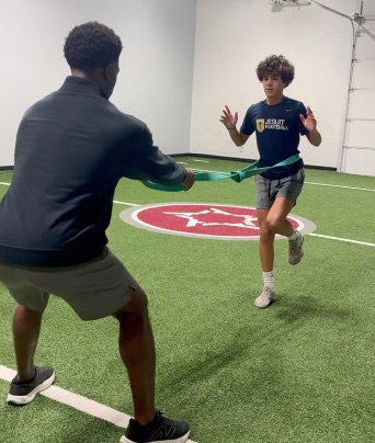 Patient working with a provider at a performance physical therapy clinic in Dallas, TX during a return-to-sport testing session
