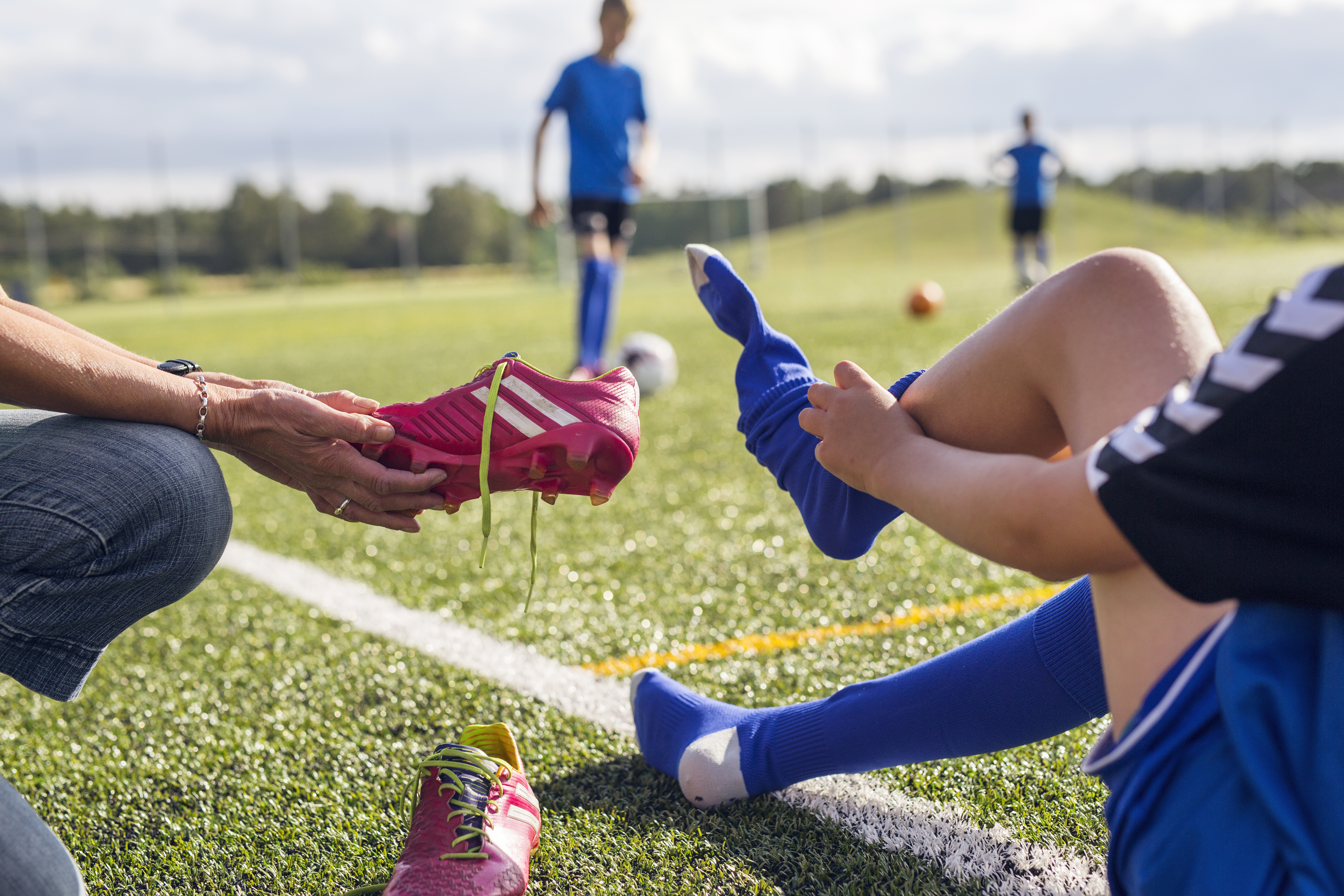 mother-helping-son-10-11-get-dressed-for-soccer-2024-10-15-02-38-43-utc